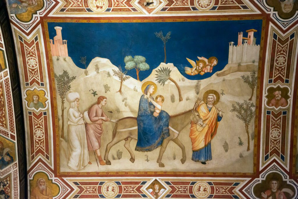 Dettaglio dell'affresco di Giotto nella basilica di San Francesco ad Assisi. Sono rappresentati Maria con Gesù bambino, in sella all'asino guidato da Giuseppe.